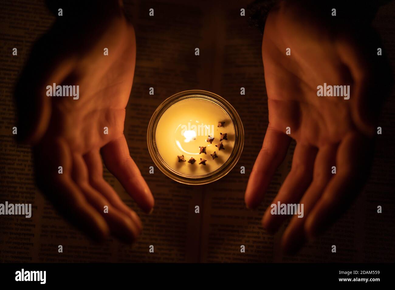 Soy candle and small hands around Stock Photo