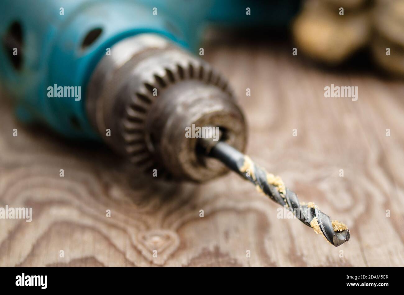 Power drill on wood with focus on drill bit Stock Photo