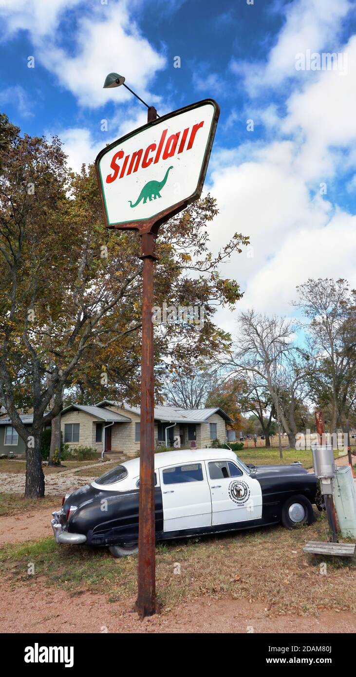 Fredericksburg,Texas - Nov. 12, 2020   Old Antique 1950  Hudson Police Car parked next to 1950's Sinclair Oil Corporation gas sign. Stock Photo