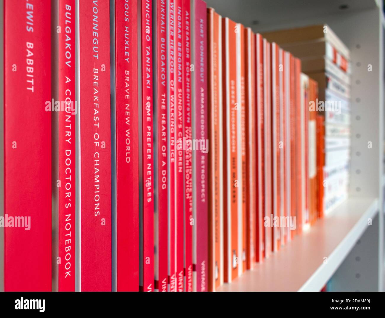 Shelf with classic orange Penguin books. Stock Photo