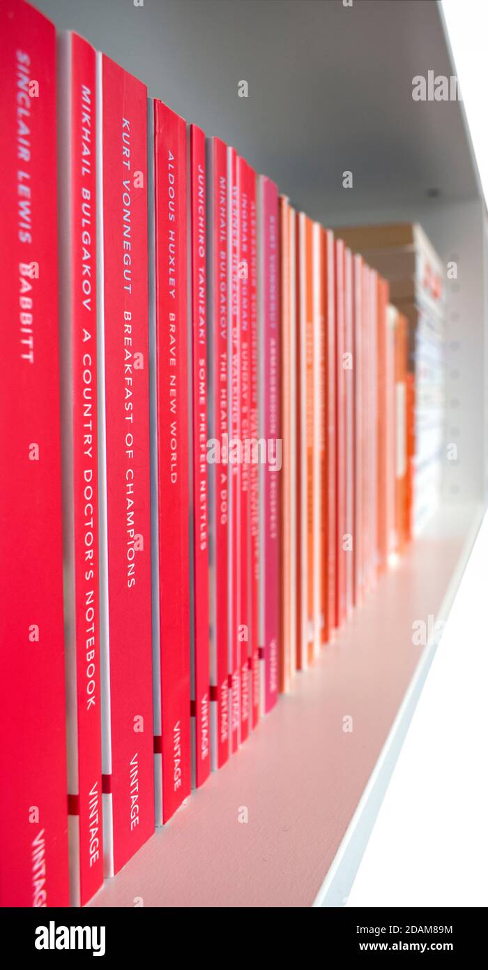 Shelf with classic orange Penguin books. Stock Photo