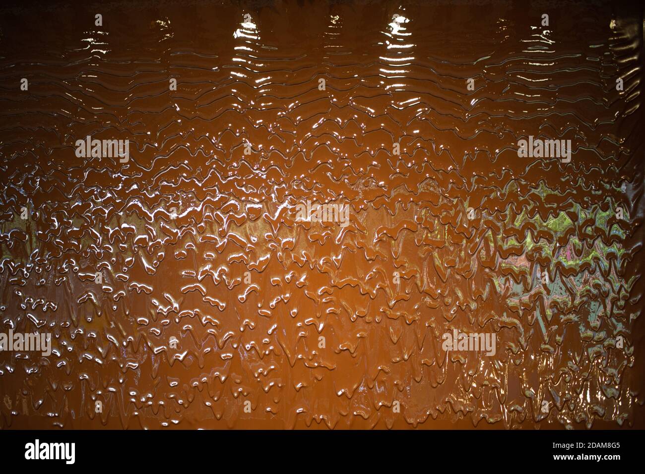 Liquid milk chocolate flowing wall with waves. Stock Photo