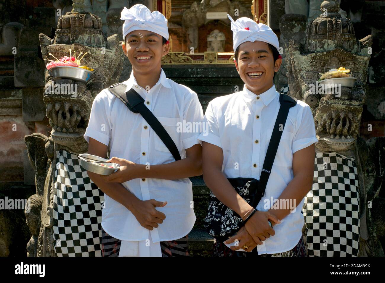 Balinese boys volunteering at the local temple. Near Ubud, Bali, Indonesia Stock Photo