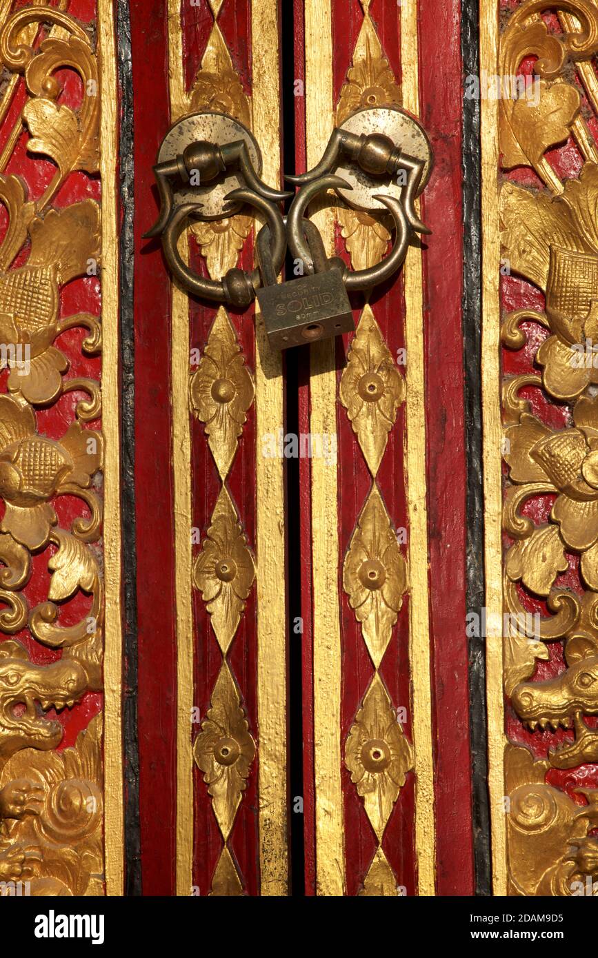 Gold and red painted door with padlock in a Hindu temple, near Ubud, Bali, Indonesia Stock Photo