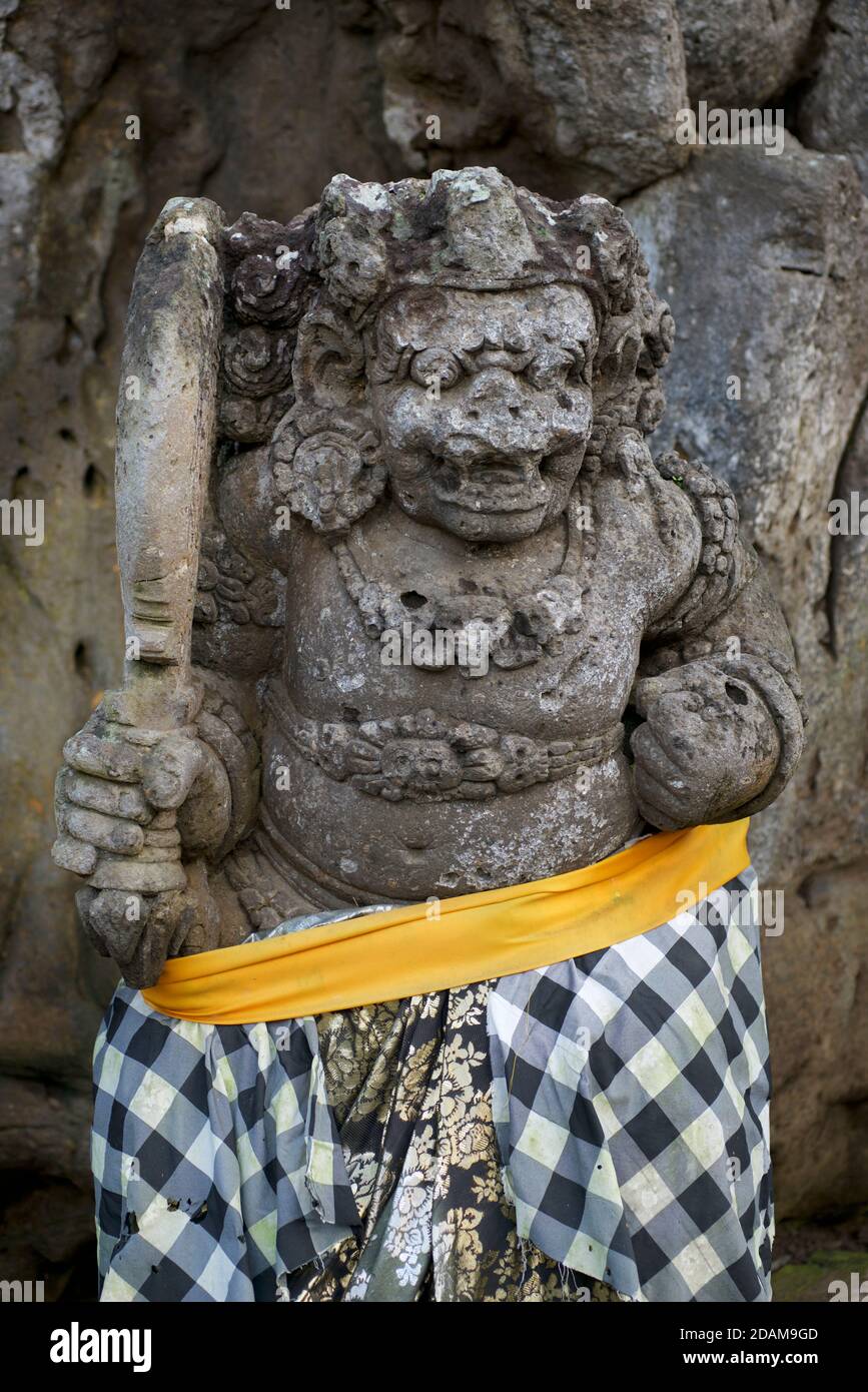 Rakasa - mythical Hindu demon-guardian with long teeth at entrance to Goa Gajah cave,  Ubud, Indonesia. Stock Photo