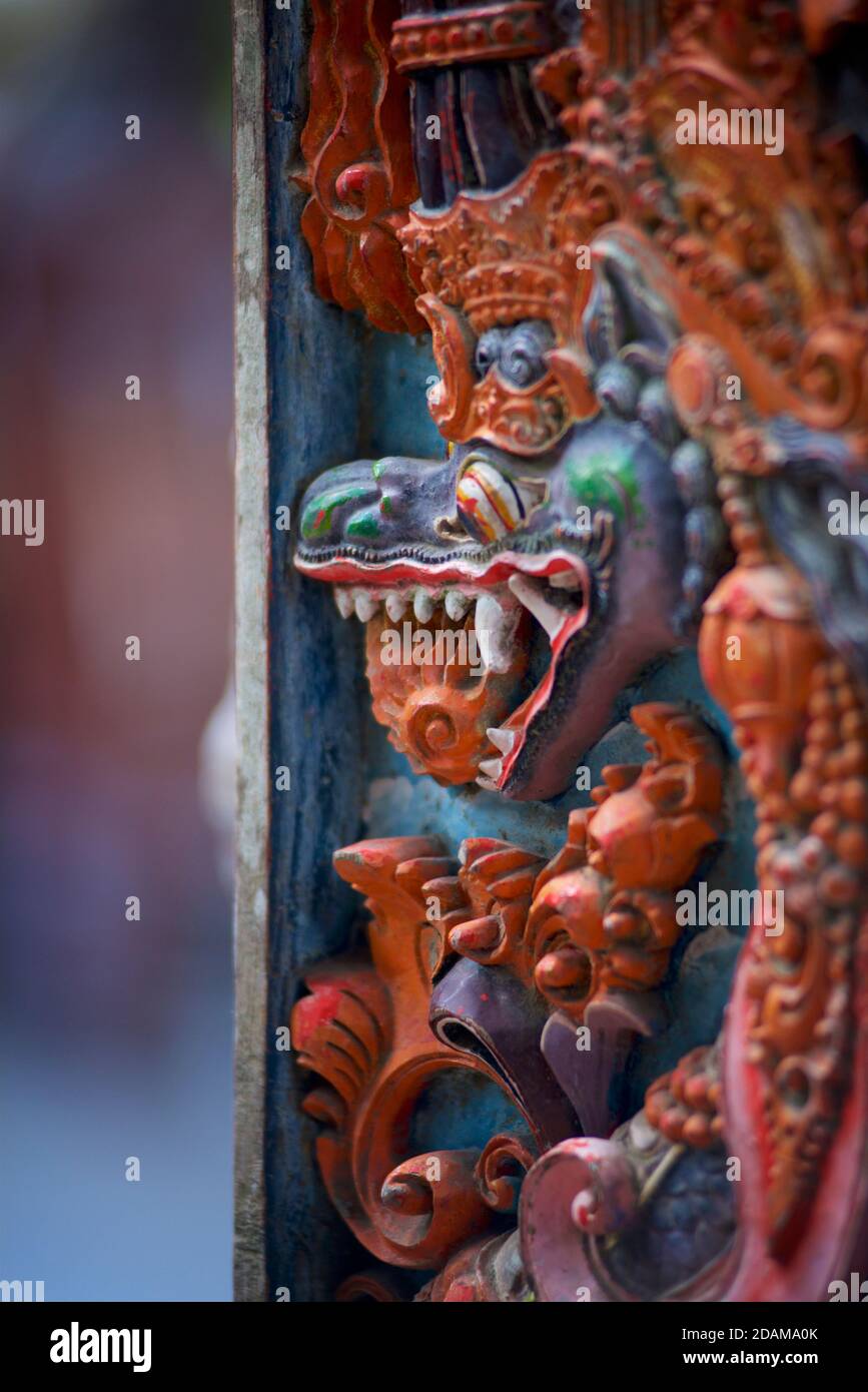 Carved and painted Naga on a door at the entrance to Tirta Empul temple, Bali, Indonesia Stock Photo