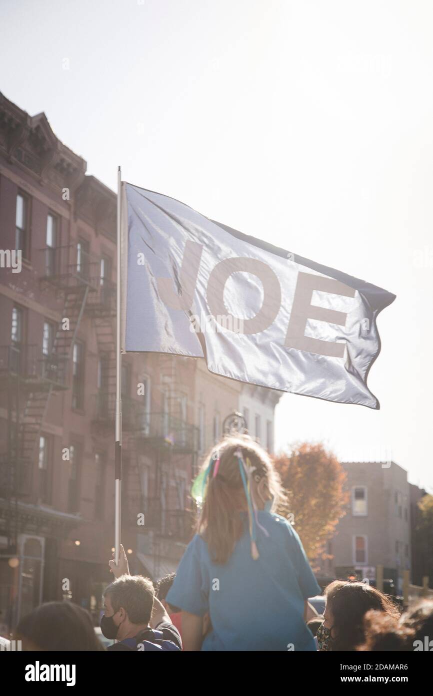 'Joe' Flag with Young Girl during Election Celebration, Brooklyn, New York, USA Stock Photo