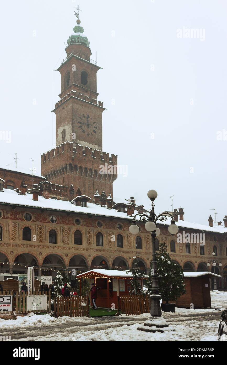 A walk in the historic center of vigevano with views of the Piazza Ducale and the sforzesco castle in Vigevano during a snowfall in 2012 Stock Photo