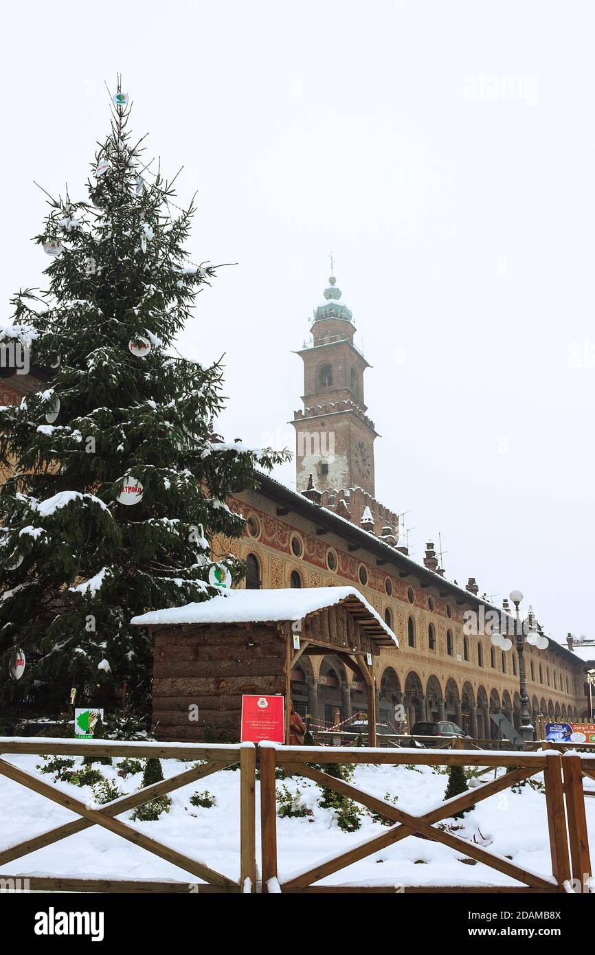 A walk in the historic center of vigevano with views of the Piazza Ducale and the sforzesco castle in Vigevano during a snowfall in 2012 Stock Photo