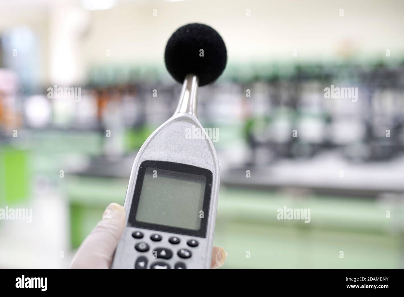 Scientist measuring the noise in a laboratory with a sound level meter. Stock Photo