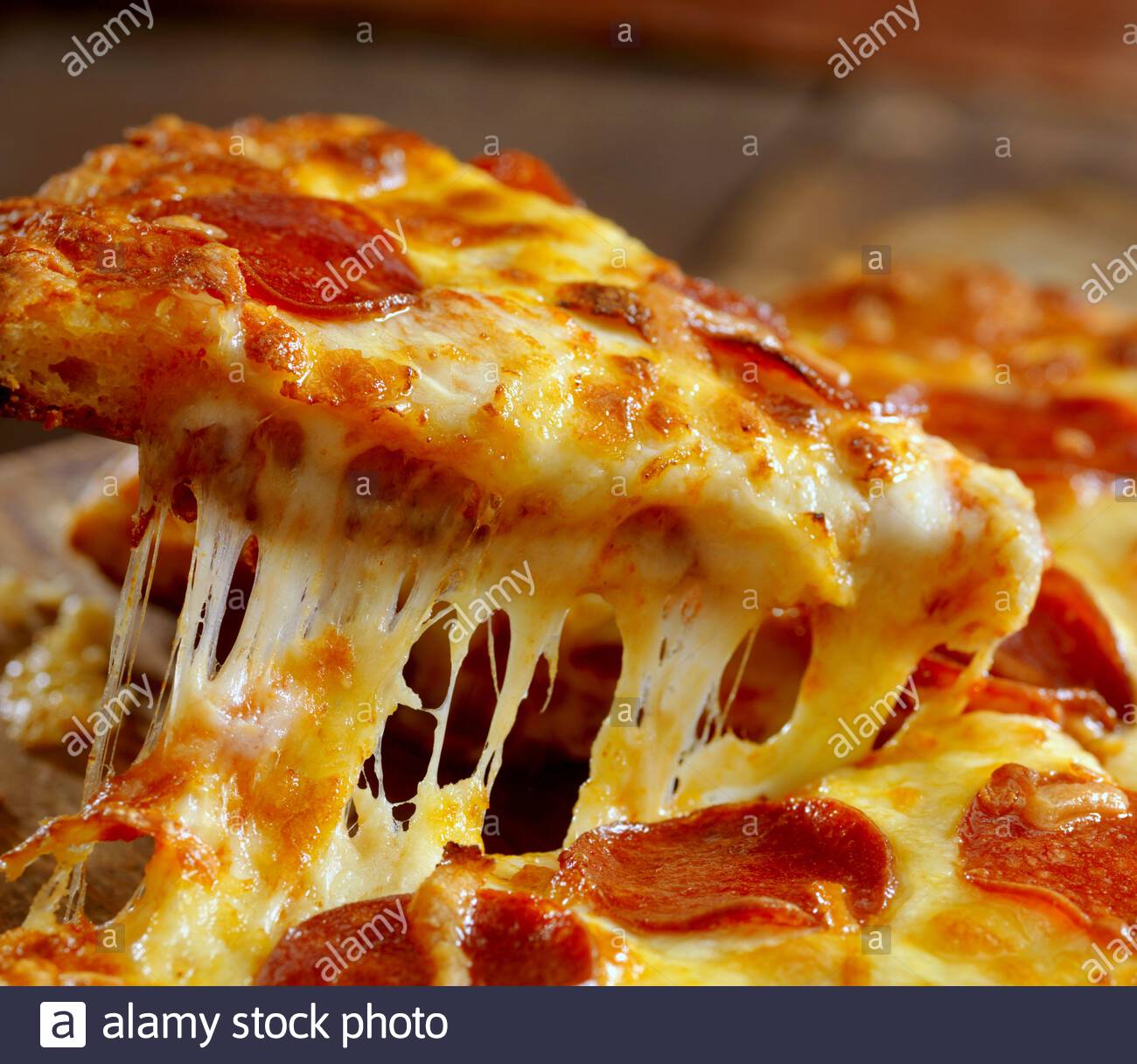 Closeup Shot Of A Pizza Slice With Melted Cheese Stock Photo Alamy