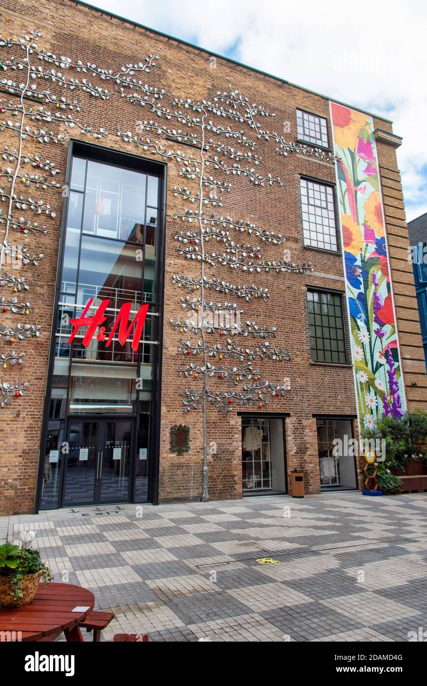 The H&M shop in London's Covent Garden with vines & leaves made of metal  seen outside with a mural that runs from the ground to the roof Stock Photo  - Alamy