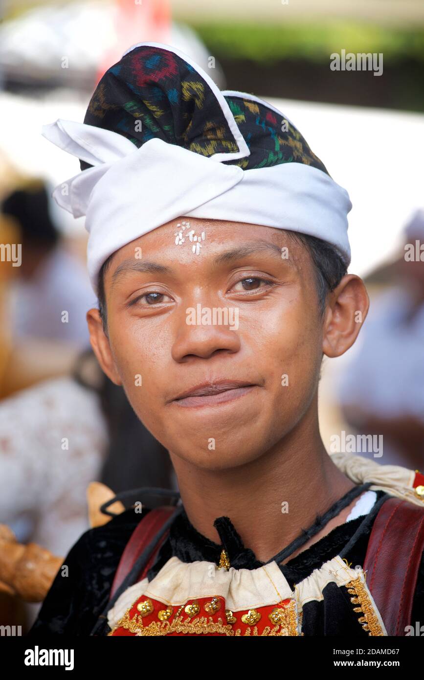 Young Balinese man in festive dance wear for temple ceremonial dance, Sakenan temple, Bali, Indonesia Stock Photo