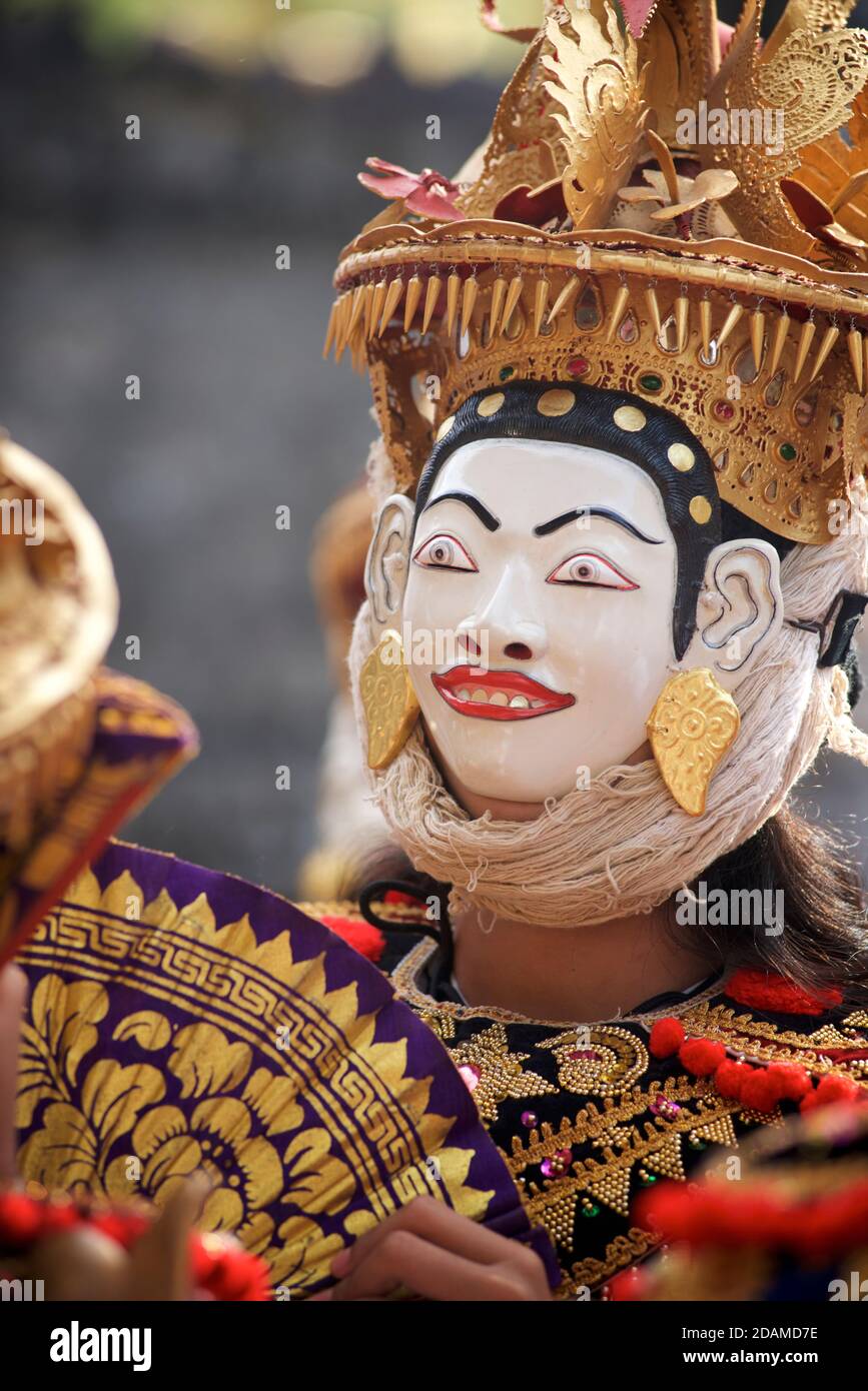 Young Balinese woman in festive dance wear for temple ceremonial dance ...