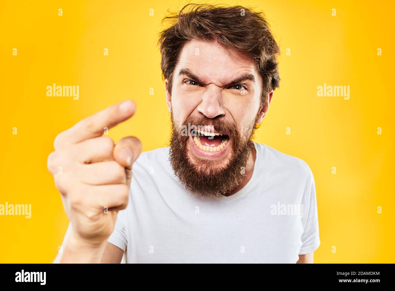 bearded man gesturing with hands studio lifestyle discontent yellow ...