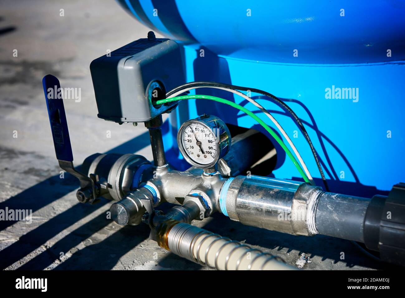 Deep water well set up. Water pressure gauge and storage tank Stock