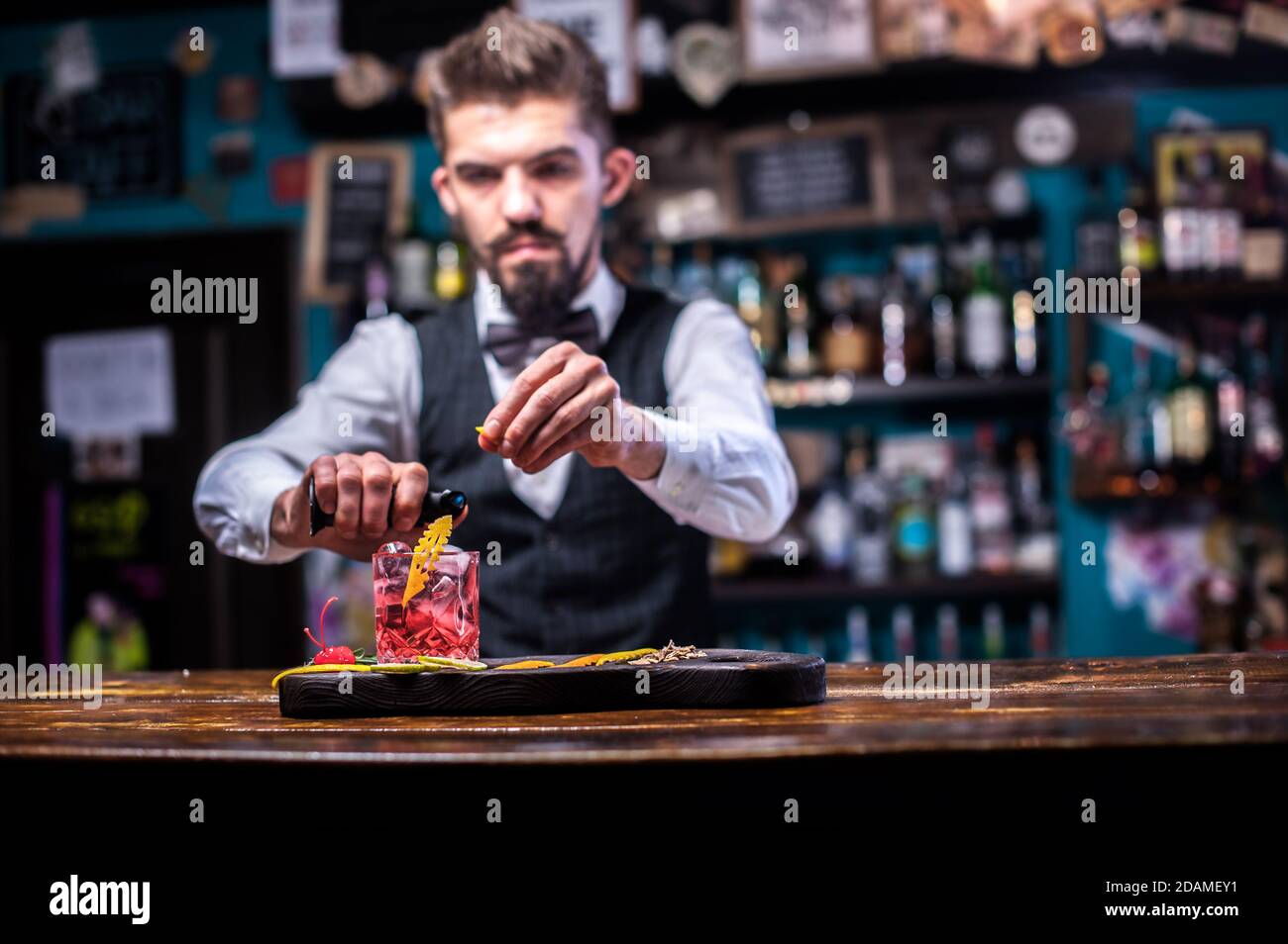Portrait of bartender makes a show creating a cocktail in the pub Stock Photo