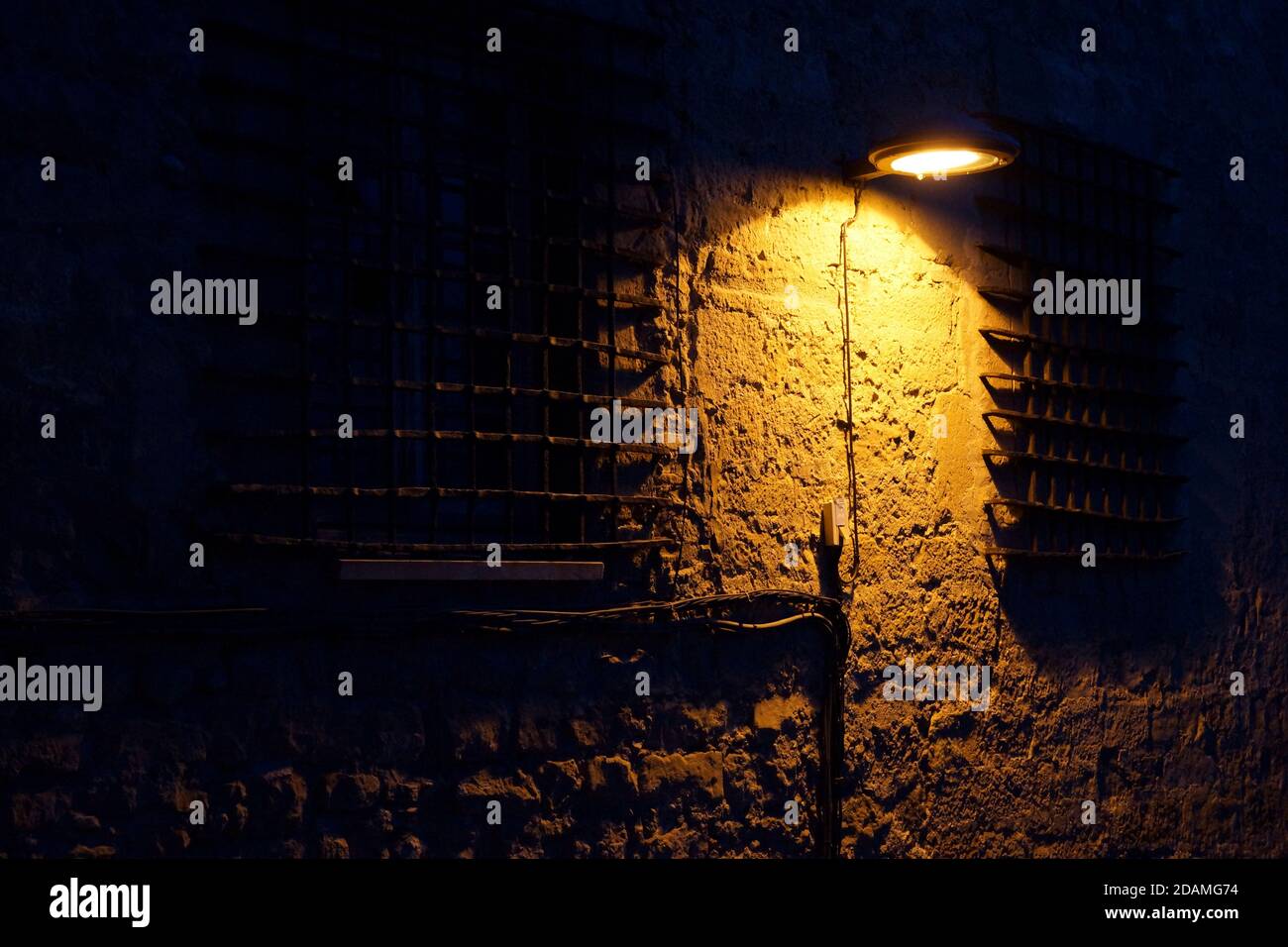 a building facade with bumpy texture and down-light Stock Photo - Alamy