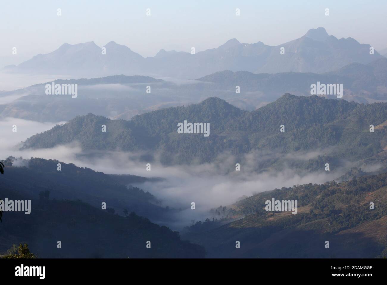 Mist over Burmese plain at early morning, viewed from Banlau, Lincang county, south Yunnan Province, China Jan 2013 Stock Photo