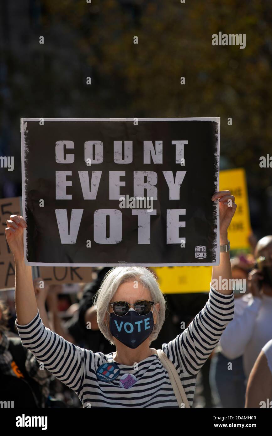 Copley Square, Boston, Massachusetts, USA, 7 Nov. 2020. A number of community organizations gathered to demand that democracy be protected and every vote in the 2020 election be counted.  Photo shows a middle aged woman with sign during demonstration. Stock Photo
