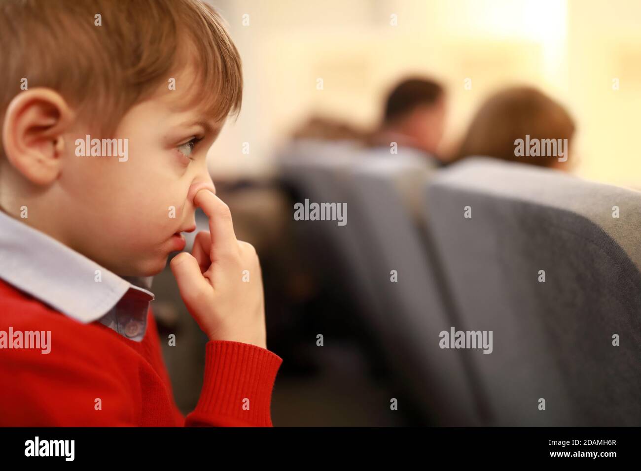 Boy picks his nose in the theater Stock Photo