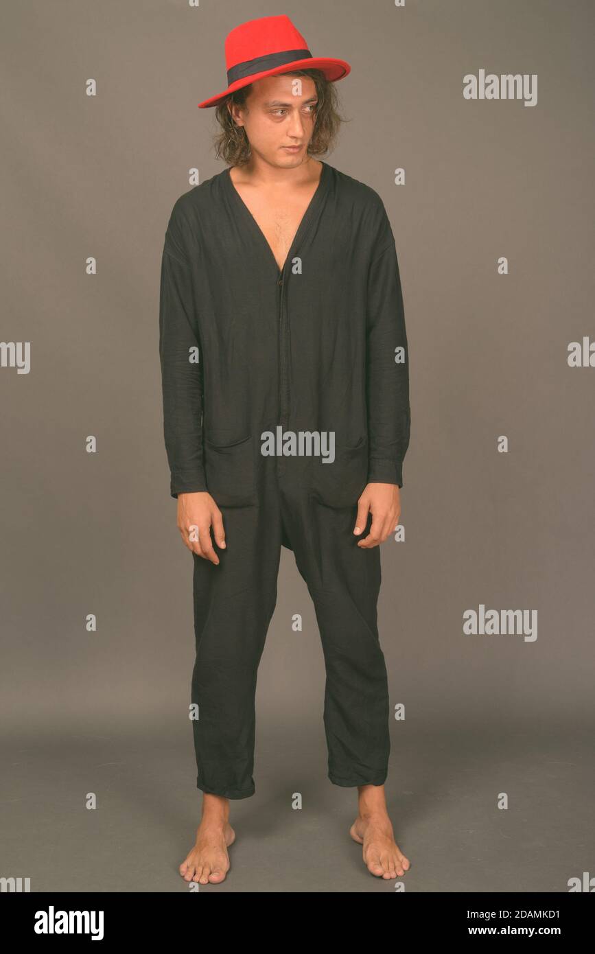 Portrait of young handsome man against gray background Stock Photo - Alamy