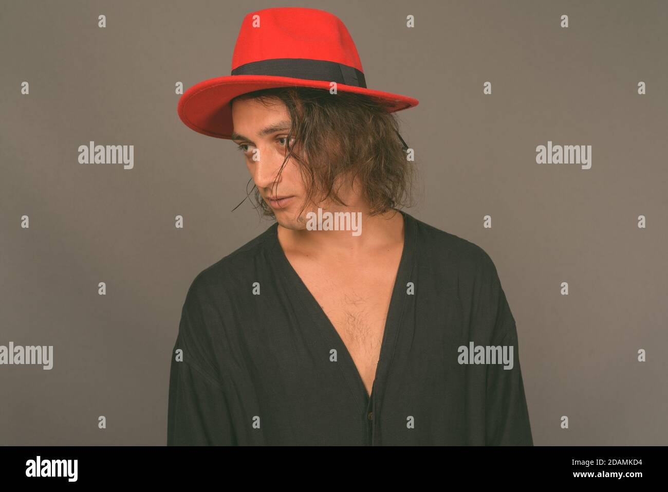 Portrait of young handsome man against gray background Stock Photo - Alamy