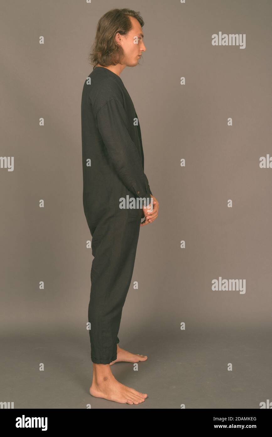 Portrait of young handsome man against gray background Stock Photo - Alamy