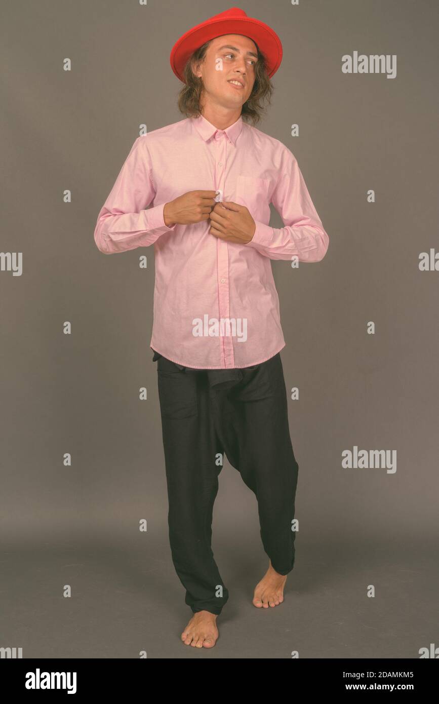 Portrait of young handsome man against gray background Stock Photo - Alamy