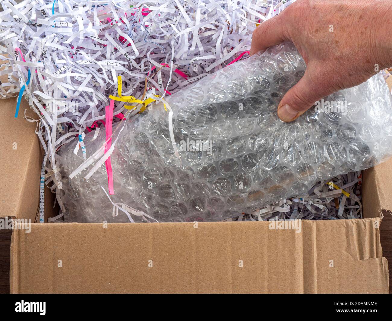 Brown shredded paper, strips of sliced corrugated eco paper for packing  Stock Photo - Alamy