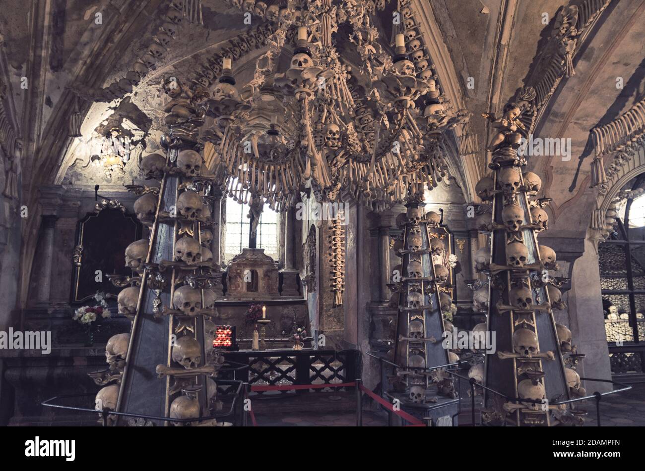 Kutna Hora, Czech Republic, May 14, 2019: Room with colonnade of human  bones and skulls. Bony lustre hang rom ceiling. Altar with crucifixion of  Jesus Christ in Kostnice Church Stock Photo - Alamy