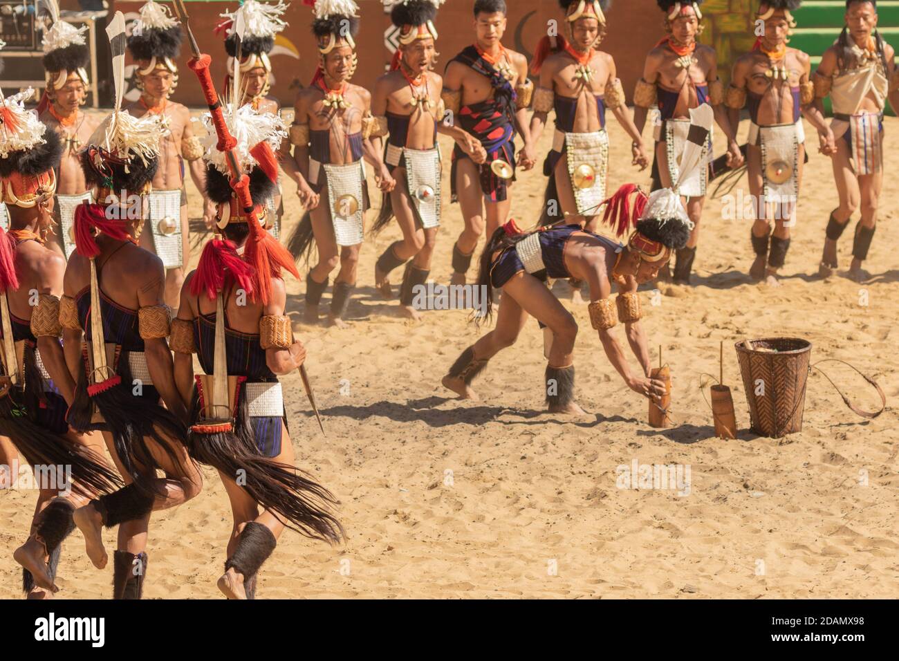 Group of naga tribesmen dressed in their traditional attire dancing during Hornbill festival in Nagaland India on 4 December 2016 Stock Photo