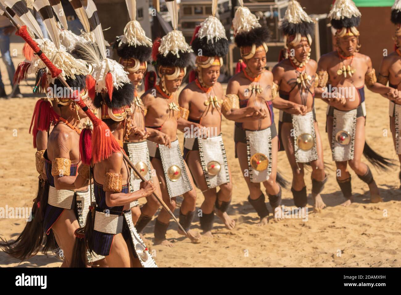 A group of naga tribesmen dressed in their traditional attire dancing during Hornbill festival in Nagaland India on 4 December 2016 Stock Photo