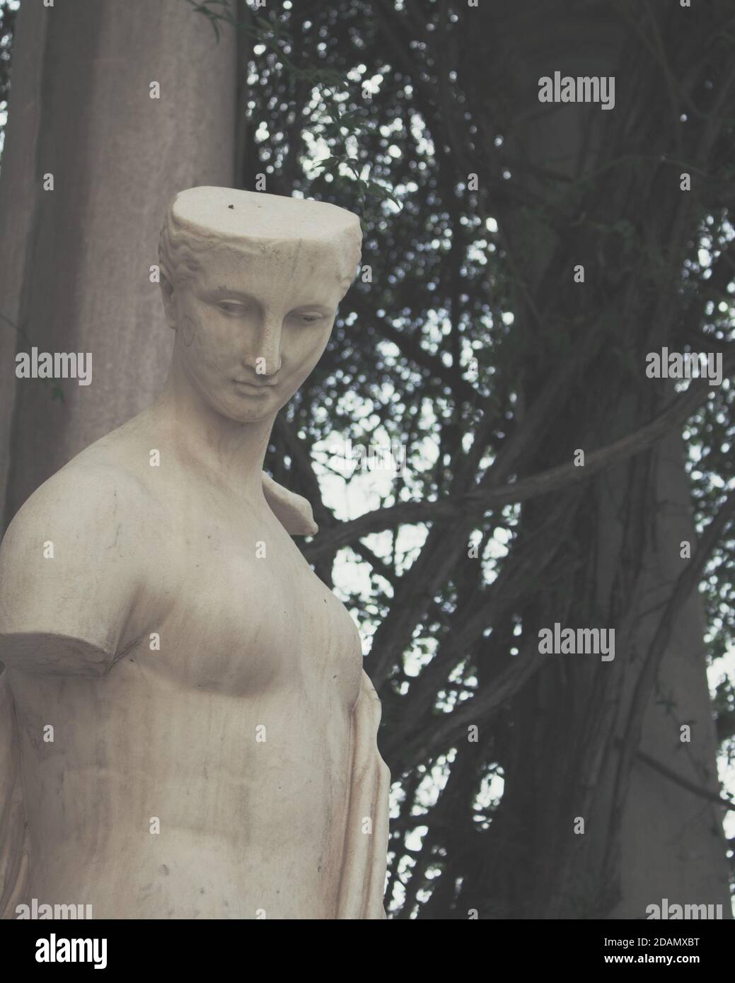 Roman male statue without arms surrounded by columns Stock Photo Alamy