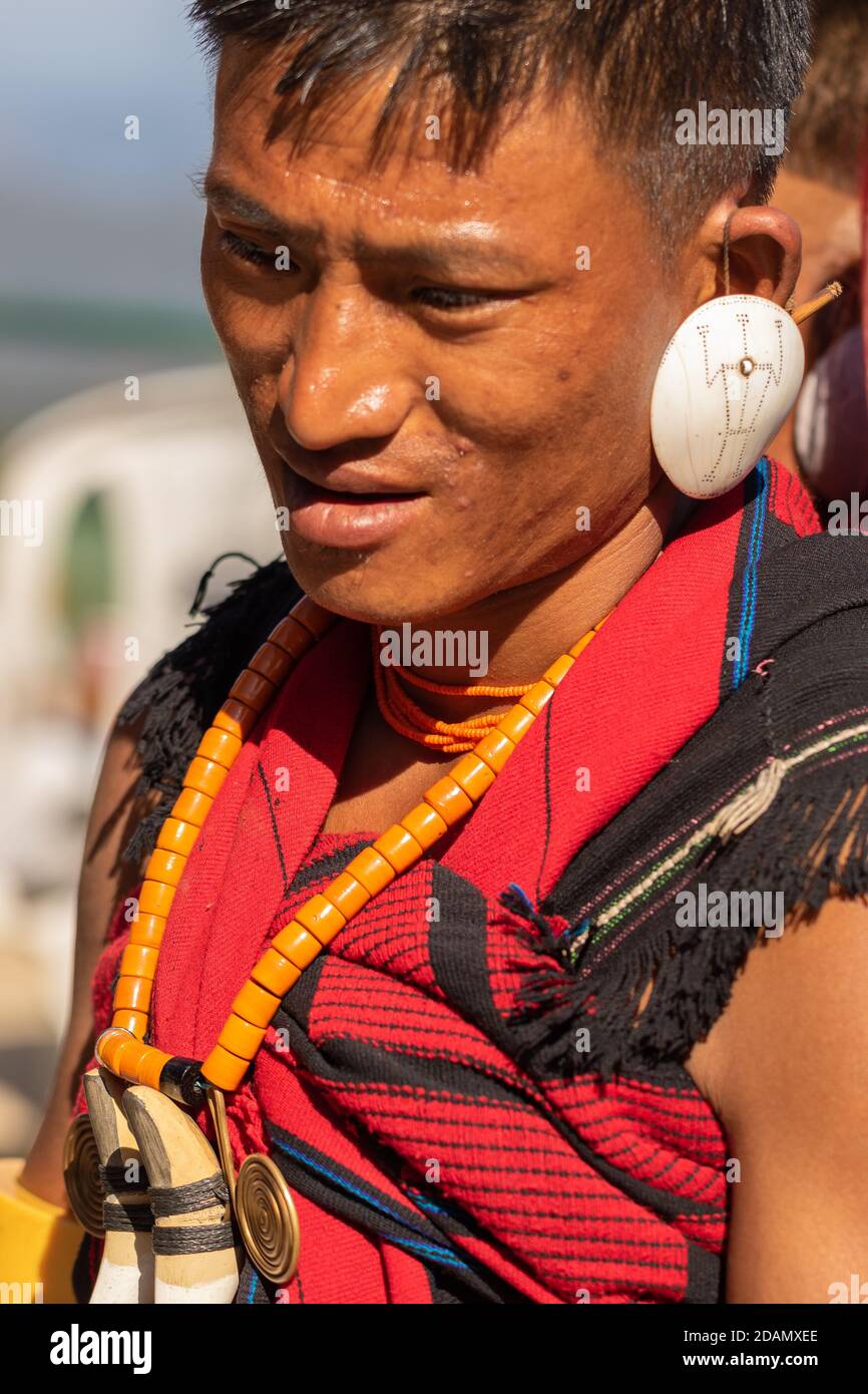 Portrait of a young Naga tribesman dressed in his tribal attire at Kisama village in Nagaland India on 4 December 2016 Stock Photo
