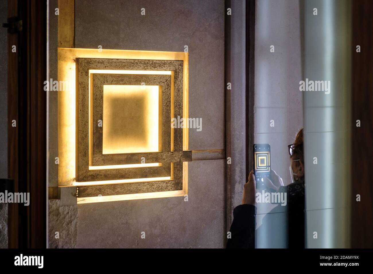 The Olivetti bright logo at the entrance of Olivetti store in Venice designed by Carlo Scarpa, photographed by a woman. Stock Photo