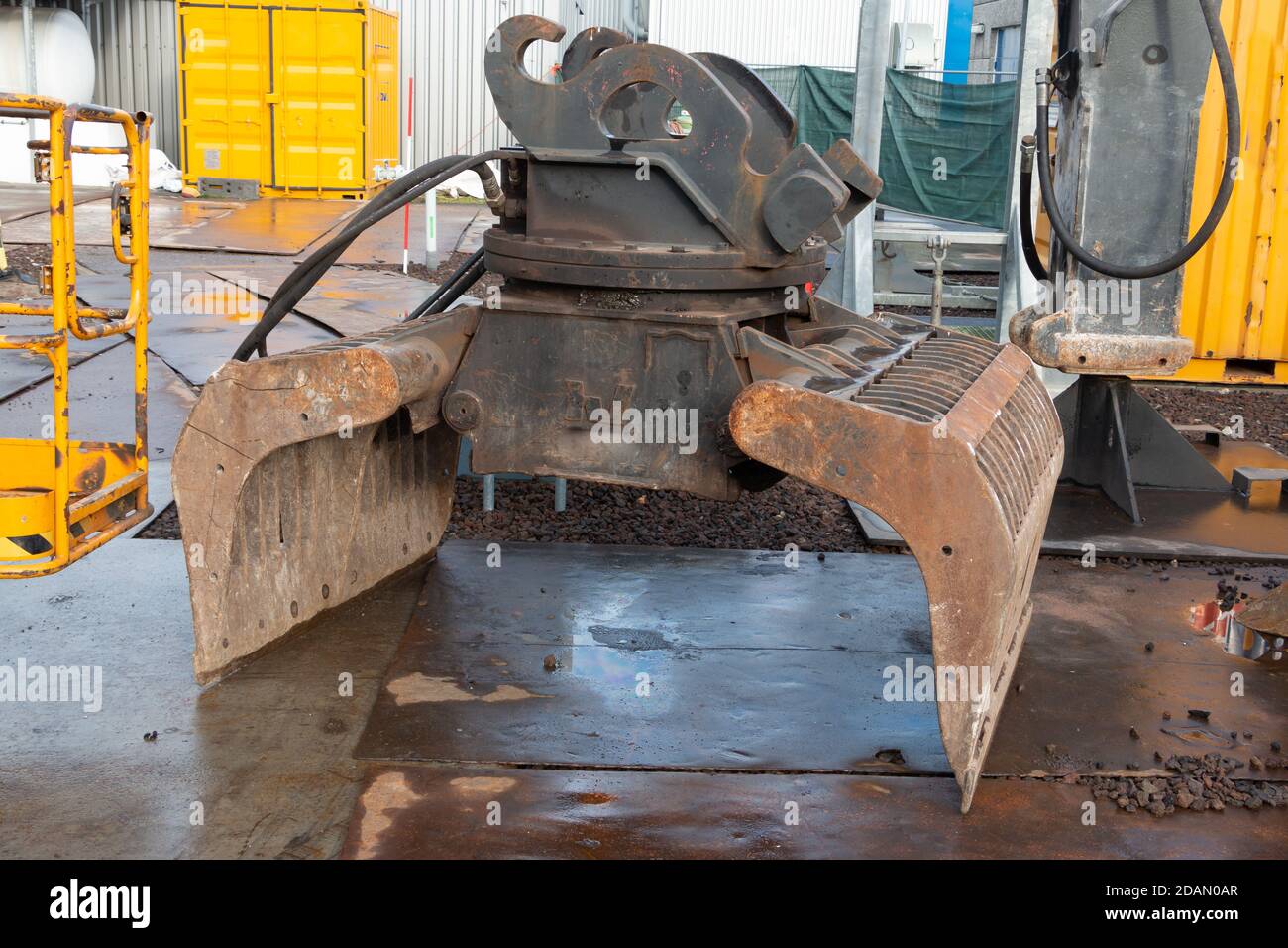 A grab or clamshell on a construction site ready for use on a excavator Stock Photo