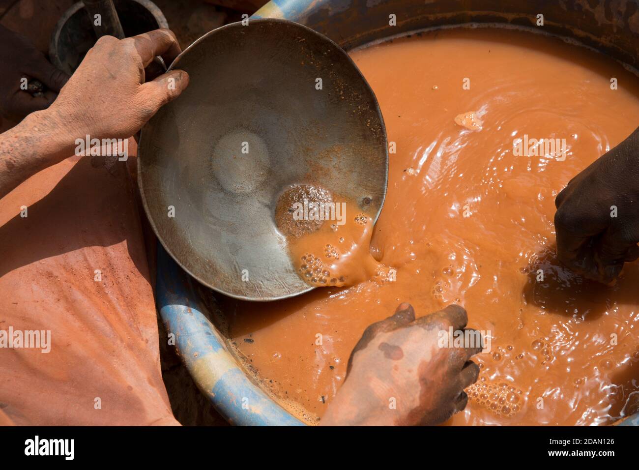 Selingue, Mali, 28th April 2015; Faraba gold mine. Modibo Ganame, 27, red singlet, and  Youssouf Porgo, 27, came from Burkina Faso to work here. Young Stock Photo