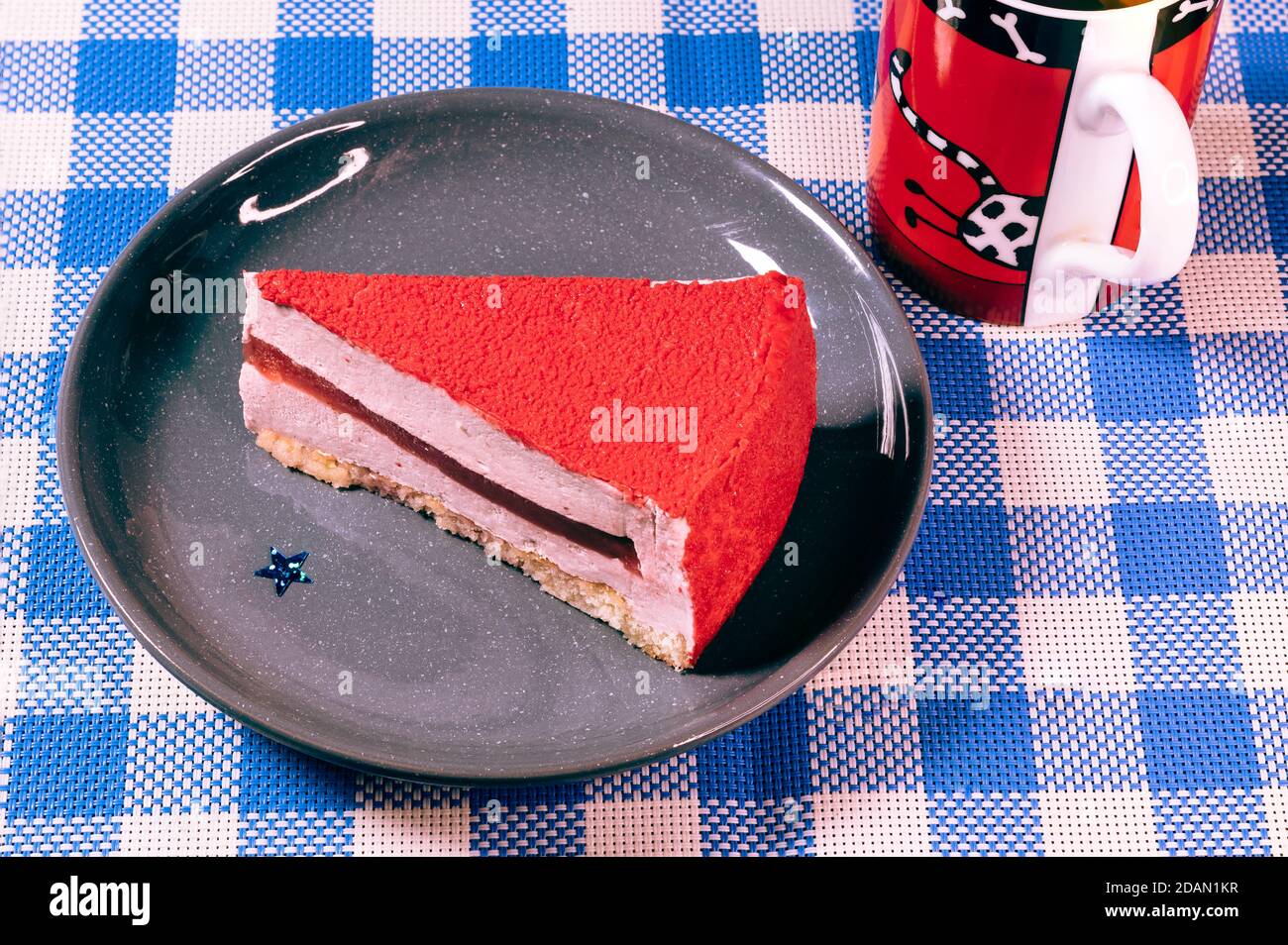 Raspberry holiday cheesecake Servings on a table with white blue  checkered tablecloth Stock Photo