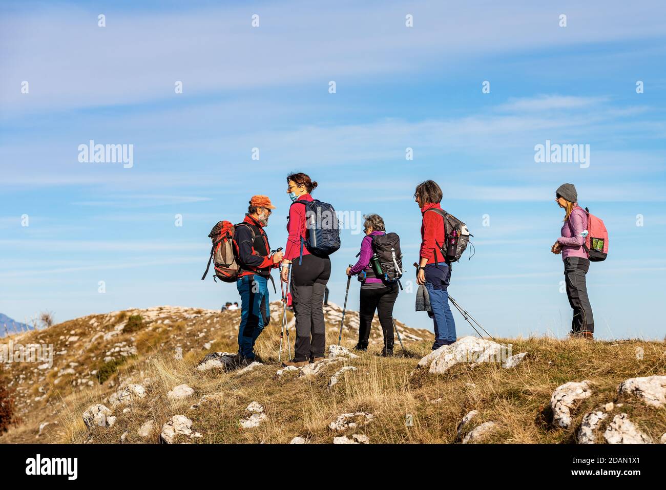 Group of seniors and adults hiking on the Lessinia plateau near the peak of Corno d'Aquilio, European Alps, Verona province, Veneto, Italy, Europe. Stock Photo
