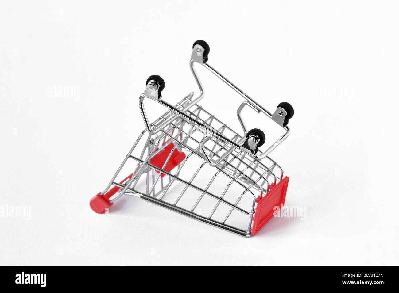 Empty inverted shopping cart on white background - Concept of shopping cart abandonment Stock Photo
