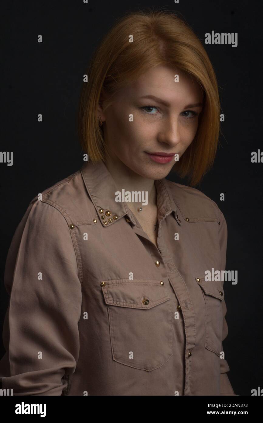 Red-haired young woman with freckles Stock Photo