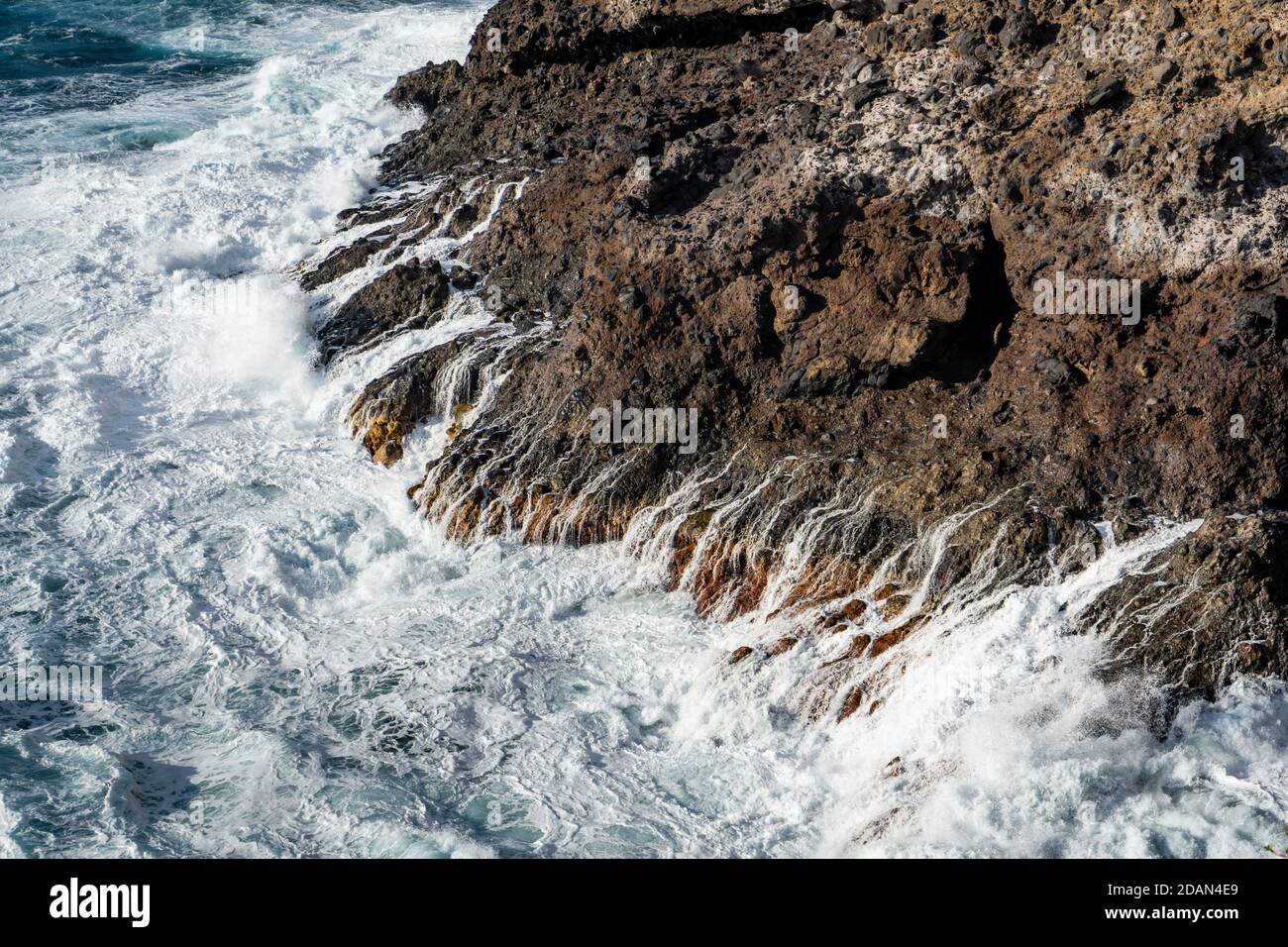 Waves breaking on rocks Stock Photo - Alamy