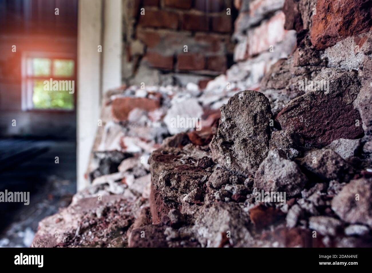 Highly damaged wall in abandoned building, close up. Stock Photo