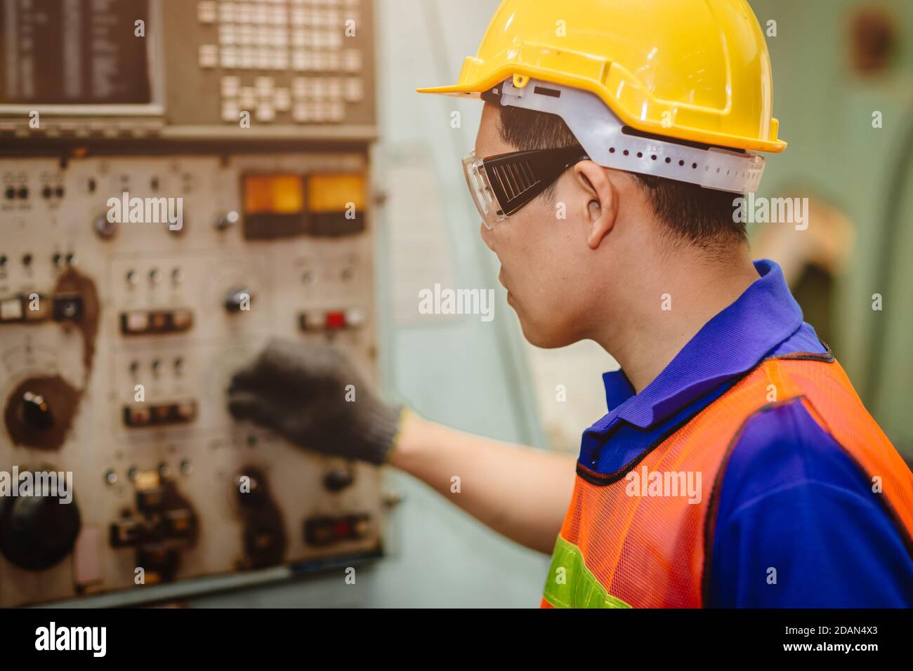 Asian labor worker hard working with control safety machine in metal factory industry. Stock Photo