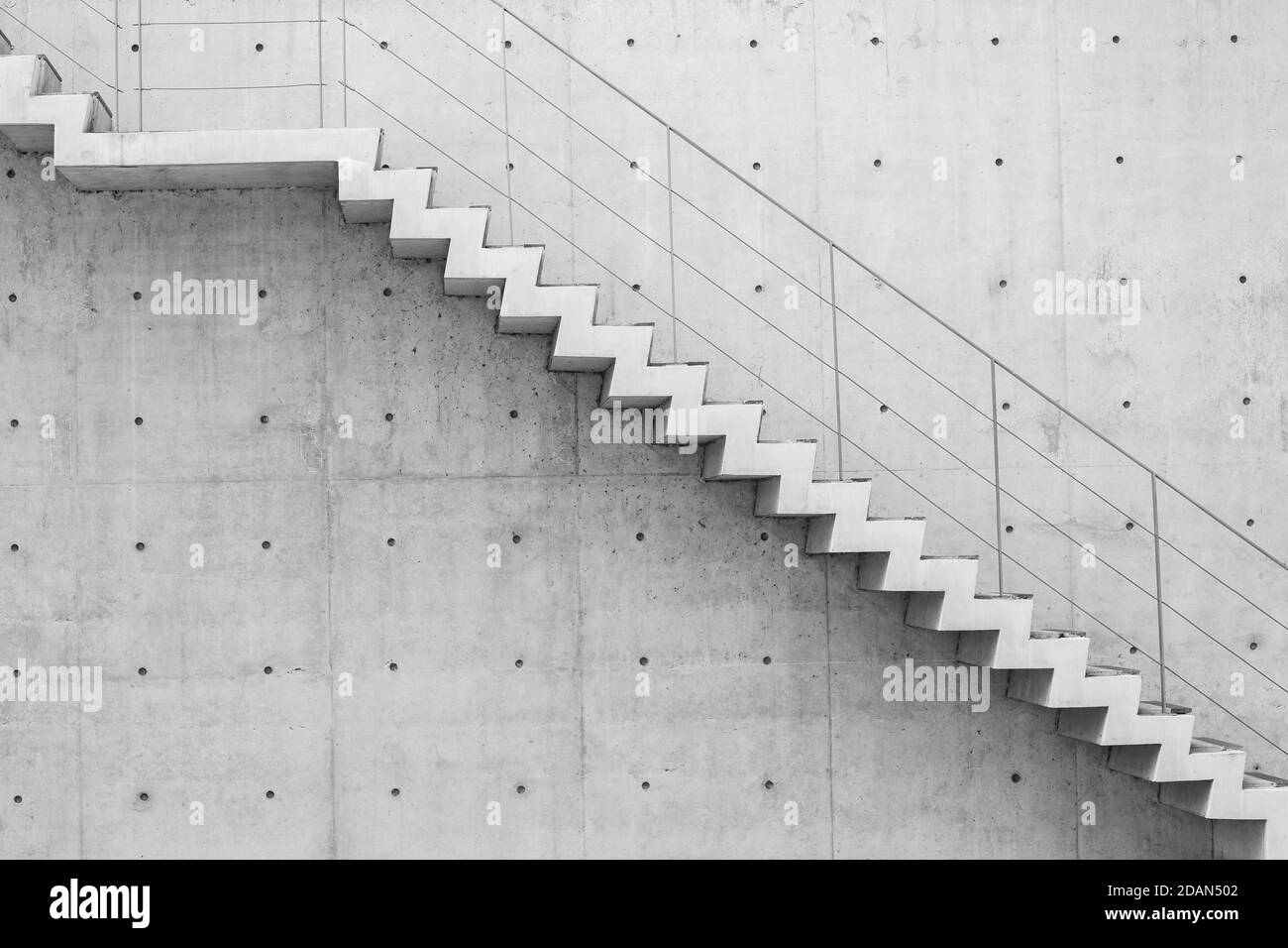concrete stair in modern building across the scene for step up or down business concept. Stock Photo