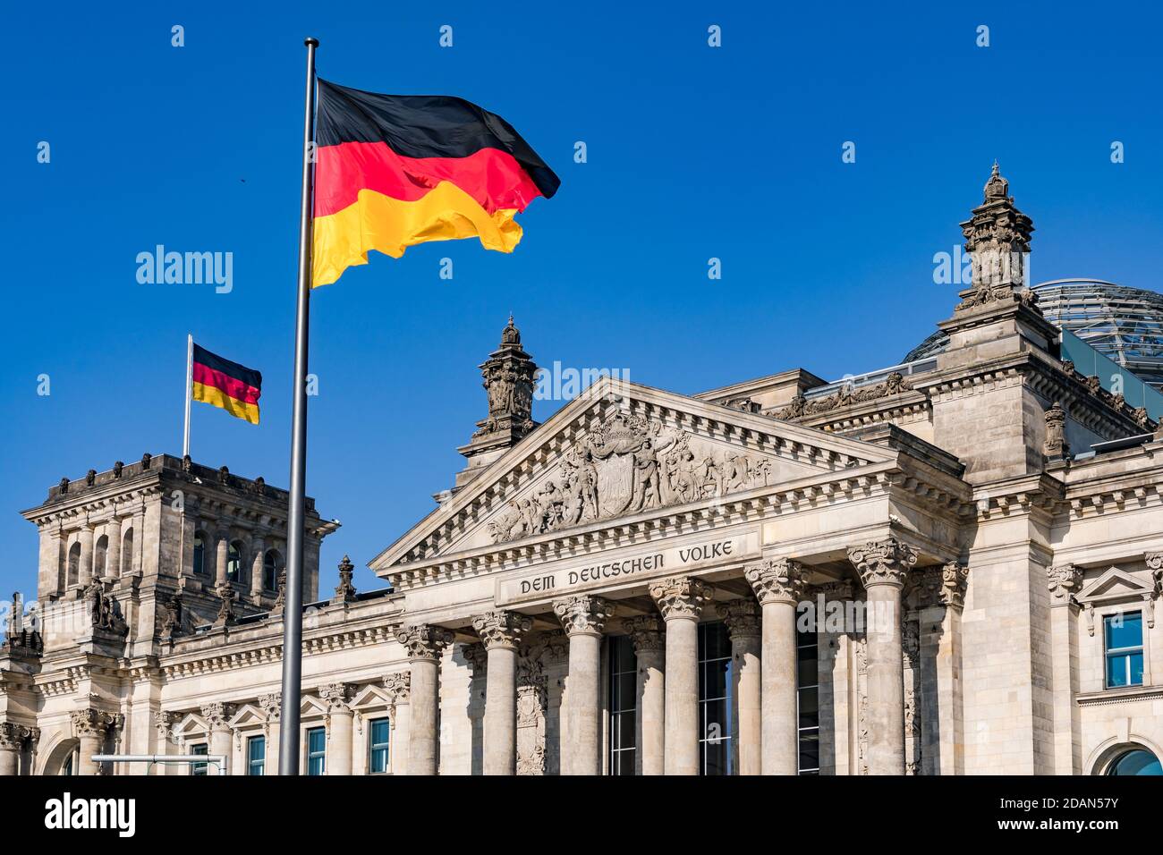 The Reichstag in Berlin with the German flag and inscription Stock Photo