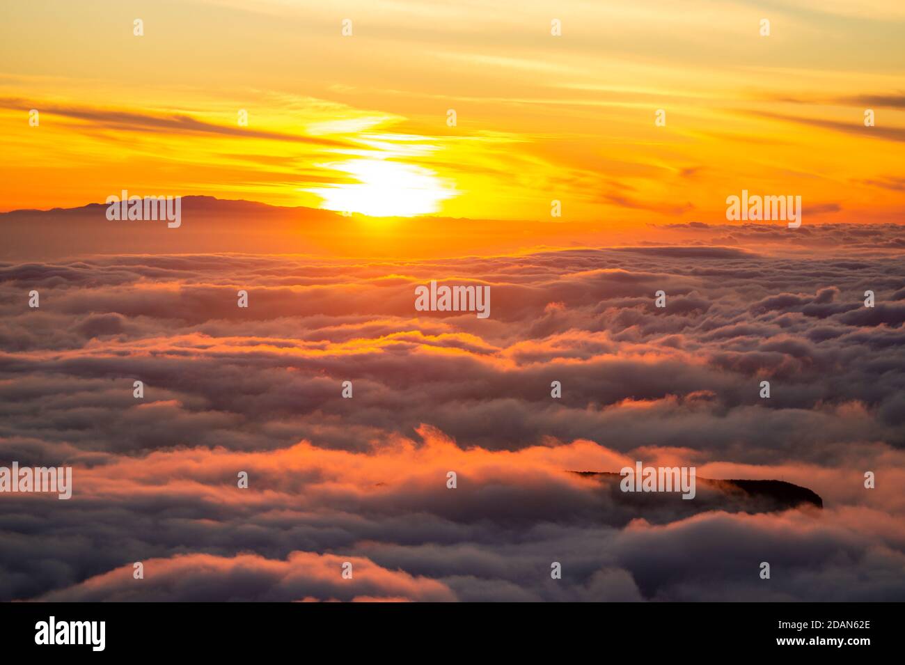 Sunset over the clouds Stock Photo