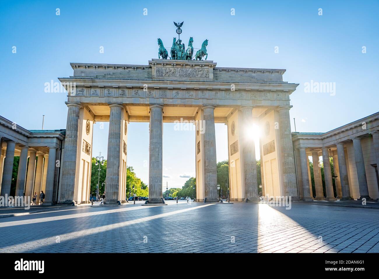 sun shining through brandenburg gate berlin germany Stock Photo