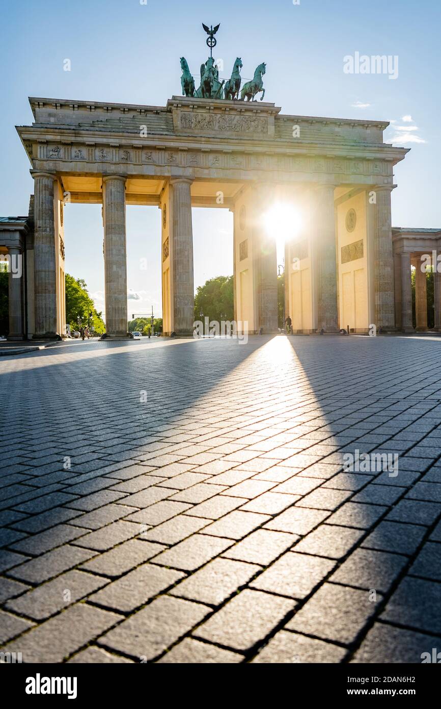sun shining through brandenburg gate berlin germany Stock Photo